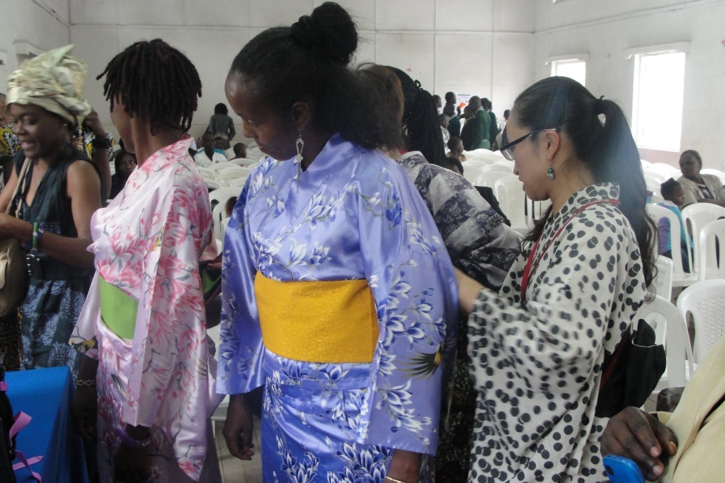 Members of the audience being assisted to put on a kimono by Japan Overseas Cooperation Volunteers, JOCV