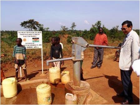 Ambassador Takata testing the hand pump at one of the project sites