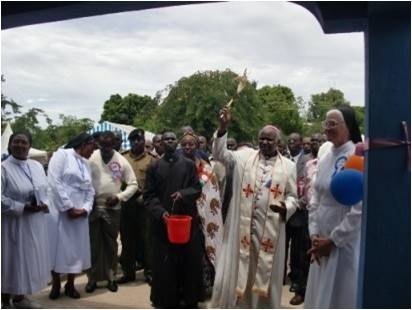 Bishop Korir giving blessings to the theatre before ribbon cutting