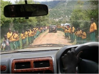 Pupils lined up along the road for welcoming guests