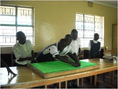 Children with mental disabilities learning weaving in the newly constructed classrooms