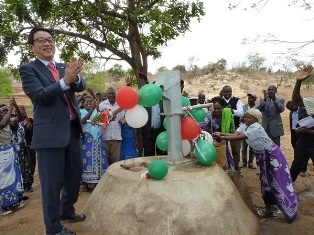 Mr. Mikio Mori pumping water at one of the newly constructed shallow wells