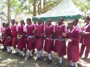Pupils from Isaangwa Primary School expressing joy by singing and dancing