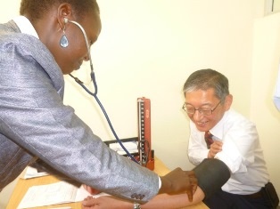 H.E. Terada receiving blood pressure