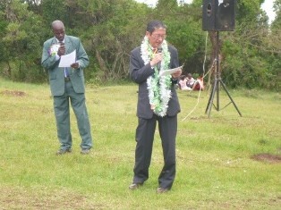 H.E. Mr. Terada giving a speech interpreted in  Kiswahili by Mr. Richard, HT of Olengoloto PS