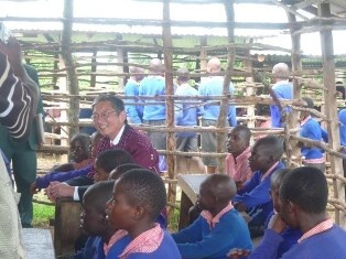 H.E. Mr. Terada greeting and sitting in the humble classroom with pupils