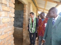 H.E. Mr. Terada touring the current school facilities with Head Teacher and Chairman