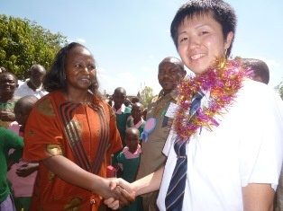 Ms. Ruth Nduku Mutua, Representative of Machakos County Government, Minister for Education, Youth and Social Welfare,  shaking hands with Mr. Yamana