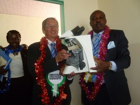 Ambassador Terada and Governor Ranguma holding a microscope.