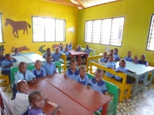 Newly built ECD classrooms and happy pupils.