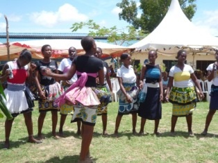 Secondary school girls singing and dancing.