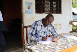 Hon. Mustafa Iddi, Member of National Assembly, signing the book