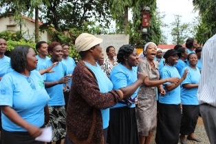 People from the community welcoming the guests with songs