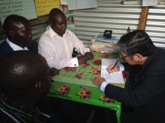 H.E. Tatsushi Terada, Ambassador of Japan, signing the visitors book in the makeshift office
