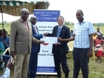 Ambassador officially releasing a cheque of USD 84,745 to the school