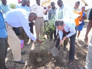 Ambassador Terada planting a tree.