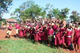 Pupils greeting the guests with Japan and Kenyan flags