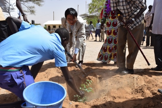 Mr. Mikio Mori, planting a tree