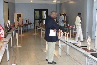 A visitor reading through a write up on the dolls.
