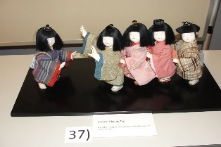 Kotoro: Playing Tag. A child is trying to catch another child who is at the end of the line.