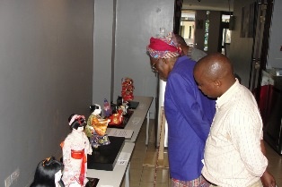 Prof. Miriam Were, Chancellor, Moi University, looking at the dolls during the official opening.