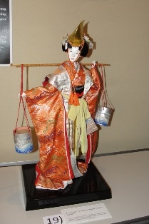 Shiokumi: Drawing water at the seaside. The title refers to a famous Kabuki dance. A beautiful young woman, having gone to draw water at the seaside, is yearning for her lover who has returned to Kyoto. Donning his headgear and clothing, she performs a dance.