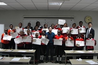 Members of the audience posing with their artwork at the end of the session