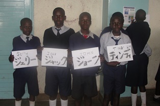 Students of Xaverian Primary School pose for a photo after writing their names at the calligraphy booth