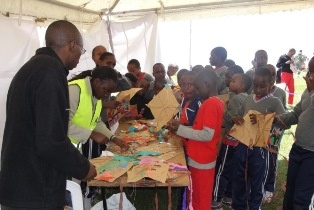 Some of the Children getting their Kites Mended at the Kites Repair Station