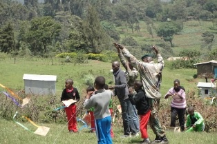 Mr. Somo of the Kenya Forest Services Flying a Kite with some Children