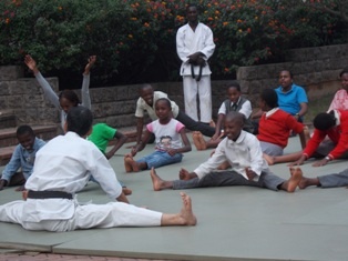 Members of the Audience Stretching after Taking Part in the Karate Demonstration
