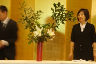 Mrs. Ishikawa standing next to one of her completed works