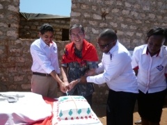 Ambassador Terada cutting a cake with Dr. Jitendra Kumar, Executive Director and  Dr. Edward Kinyanjui, Technical Director of Ananda Marga Universal Relief Team, AMURT.