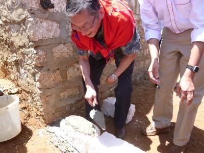 Ambassador Terada laying the stone at the project site.