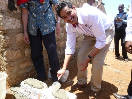 Dr. Kumar, Executive Director of Ananda Marga Universal Relief Team (AMURT) laying the stone.