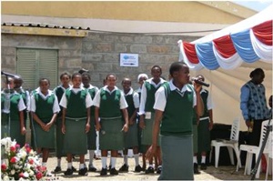 Local community students sing as a gesture of appreciation