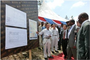 Mr. Yamada and Mr. Bor listening to a brief on the project by the contractor