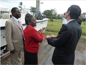 Ambassador Takata handing over the Speed Boat key directly to Hon. Murugi