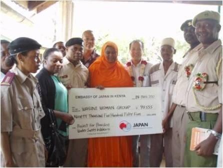 Mr. Okada hands over a dummy cheque to the recipient group