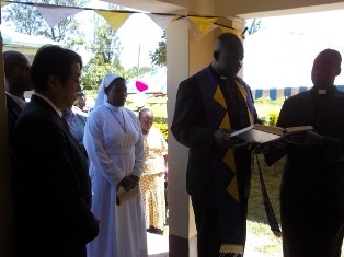 Rev. Fr. Christpher Wanyonyi praying for the official launching of the building