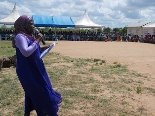 Mrs. Juliana Rumba, The Head Teacher of Gora Primary School giving a speech