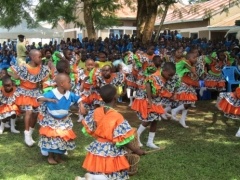 Pupils expressing joy by performing traditional Isukuti dance
