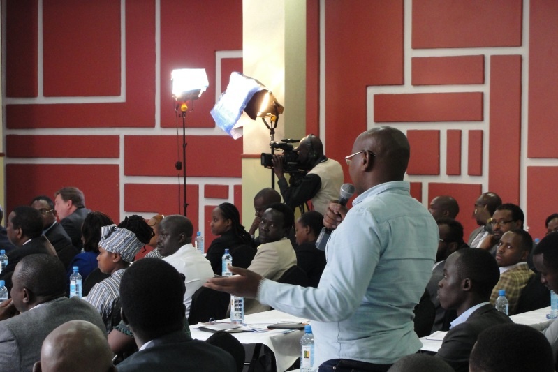 A member of the audience asking a question to the panelists