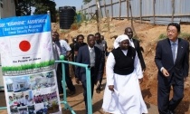 Minister Mori, Principal Sister Olang’, and community members inspect the new dormitory.