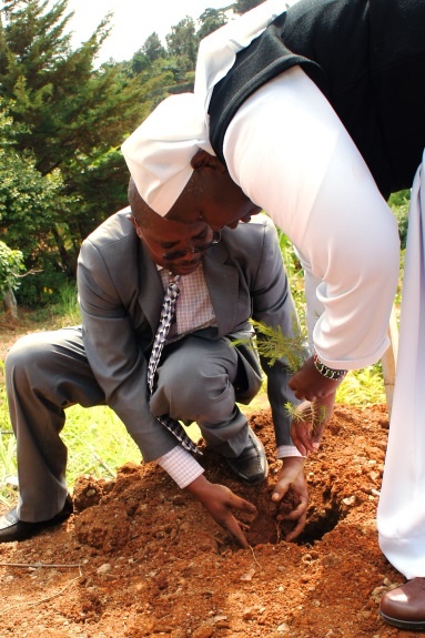 Sister Olang’ (principal) planting a tree to commemorate the occasion