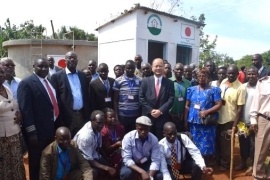 Community members gathering in front of the water kiosk