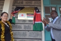 Ms. Takashima and Hon. Raymond Moi unveiling the plaque